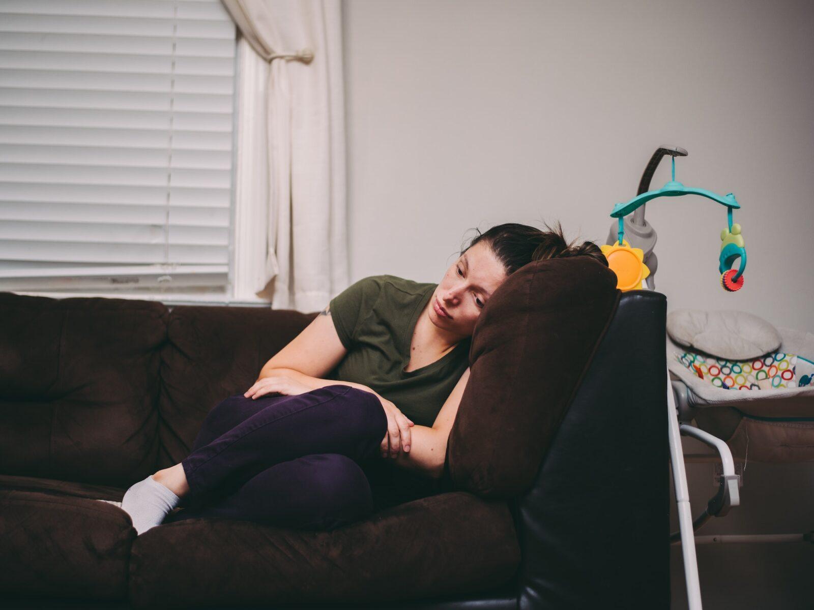 A mother who is feeling lonely, tired and sad. Postpartum depression, anxiety, motherhood